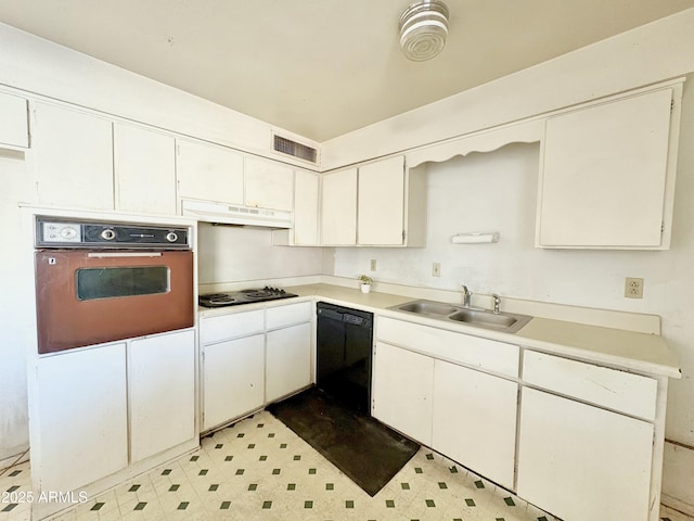 kitchen with a sink, electric stovetop, black dishwasher, under cabinet range hood, and wall oven