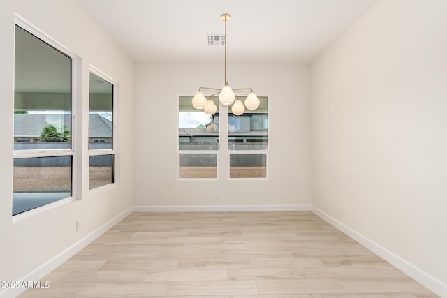 1645 E Minton St, Mesa, AZ 85203 - empty room featuring visible vents, baseboards, a chandelier, and light wood-style floors