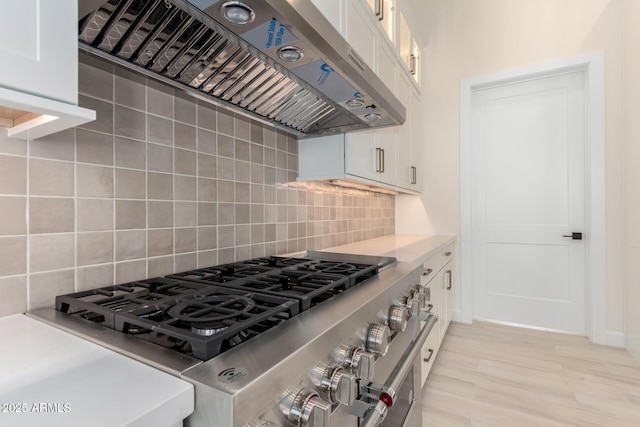 1645 E Minton St, Mesa, AZ 85203 - kitchen with decorative backsplash, range hood, light countertops, and white cabinets