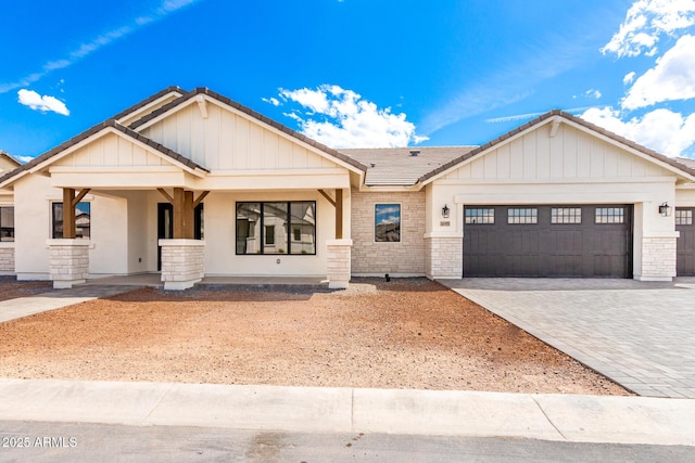 1645 E Minton St, Mesa, AZ 85203 - view of front of home featuring stone siding, a tile roof, decorative driveway, and a garage