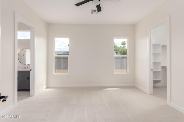 1645 E Minton St, Mesa, AZ 85203 - unfurnished bedroom with visible vents, baseboards, connected bathroom, and light colored carpet