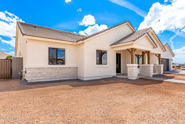 1645 E Minton St, Mesa, AZ 85203 - view of front of property with a garage, stucco siding, stone siding, and a tile roof