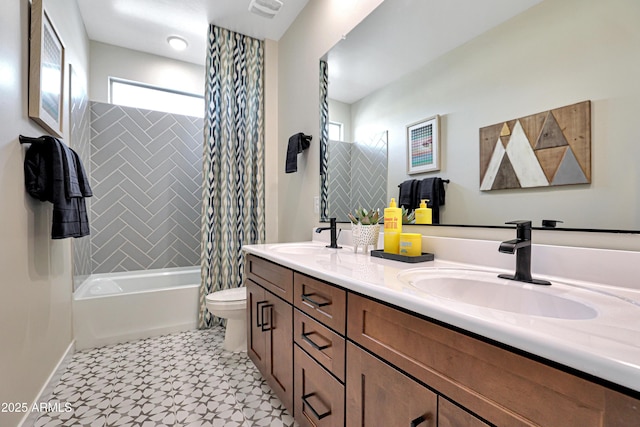 full bathroom featuring tiled shower / bath, a healthy amount of sunlight, toilet, and vanity