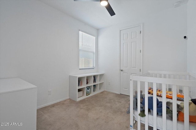 6313 N 68th Dr, Glendale, AZ 85303 - unfurnished bedroom featuring carpet floors, baseboards, a ceiling fan, and a nursery area