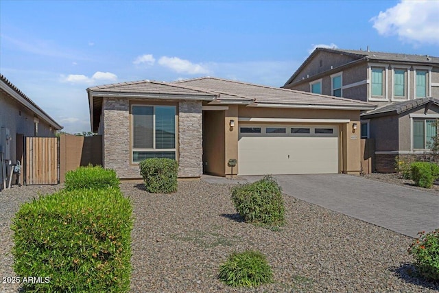 6313 N 68th Dr, Glendale, AZ 85303 - view of front of property featuring a garage, a tiled roof, decorative driveway, stucco siding, and fence