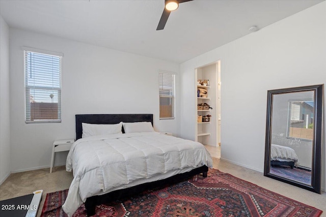 6313 N 68th Dr, Glendale, AZ 85303 - bedroom with multiple windows, light carpet, a ceiling fan, and baseboards
