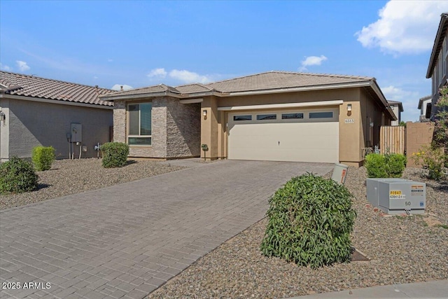 6313 N 68th Dr, Glendale, AZ 85303 - view of front of property featuring a garage, stucco siding, decorative driveway, and a tile roof