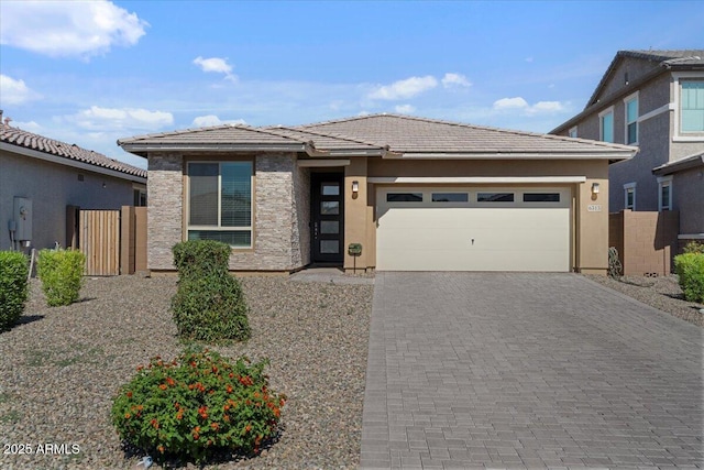 6313 N 68th Dr, Glendale, AZ 85303 - view of front of house with decorative driveway, a garage, stucco siding, a tile roof, and fence