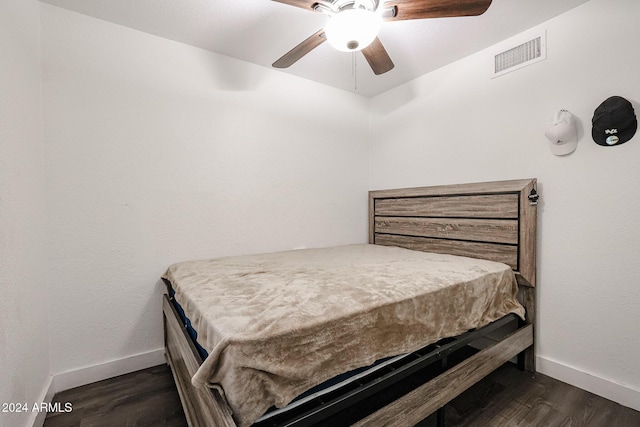 bedroom with ceiling fan, visible vents, baseboards, and dark wood-type flooring