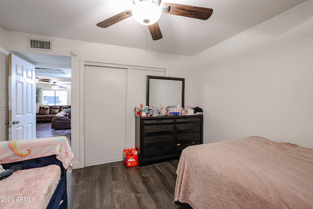 bedroom with a closet, ceiling fan, and dark hardwood / wood-style flooring