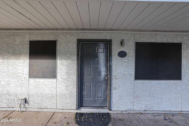entrance to property featuring stucco siding