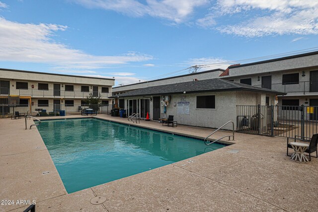 community pool featuring a patio and fence