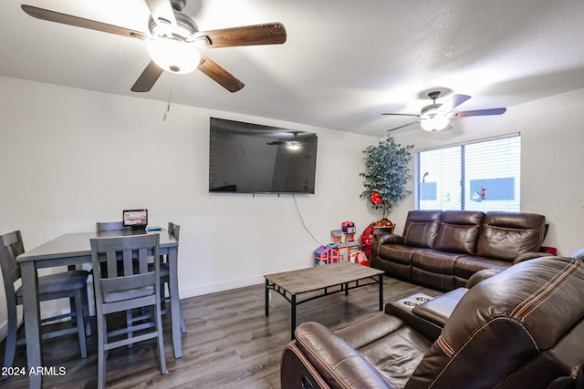 living room featuring hardwood / wood-style floors, a textured ceiling, and ceiling fan