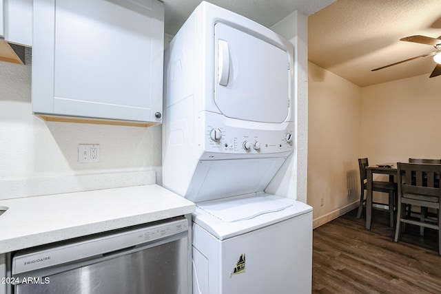 laundry area with dark wood-type flooring, stacked washer and dryer, a textured ceiling, and ceiling fan