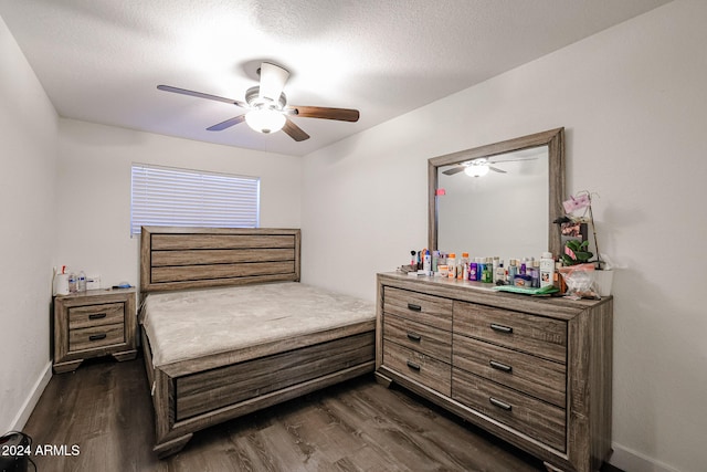 bedroom with a textured ceiling, ceiling fan, and dark hardwood / wood-style flooring