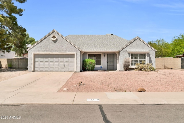 single story home with concrete driveway, fence, and a garage