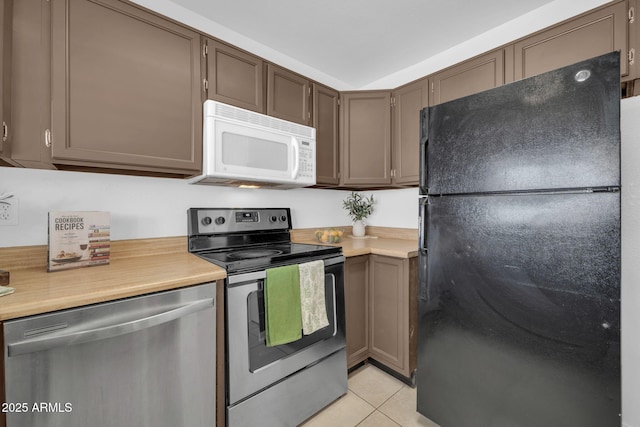 kitchen with light countertops, appliances with stainless steel finishes, and light tile patterned floors