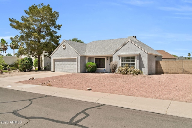 ranch-style home featuring fence, driveway, and a garage