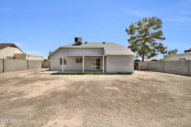 rear view of property with a fenced backyard, a patio area, stucco siding, and cooling unit