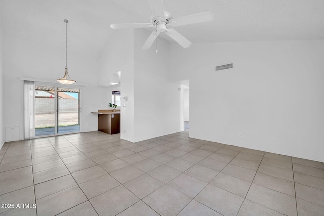 unfurnished living room with light tile patterned floors, high vaulted ceiling, a ceiling fan, and visible vents