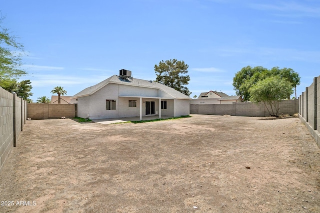 back of house featuring a fenced backyard, a patio area, and stucco siding