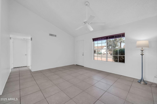unfurnished room featuring tile patterned flooring, ceiling fan, high vaulted ceiling, and visible vents