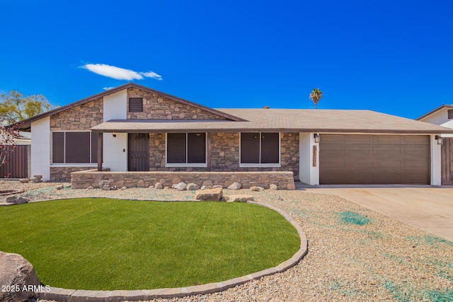 view of front of home with concrete driveway, a garage, stone siding, and a front lawn