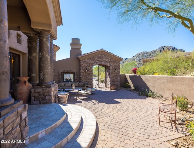 view of patio / terrace with a mountain view and an outdoor hangout area