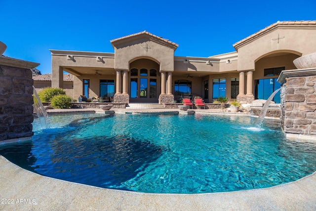 view of swimming pool with pool water feature, ceiling fan, and a patio