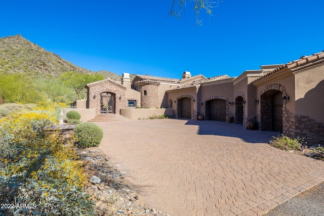 view of front facade with a mountain view and a garage