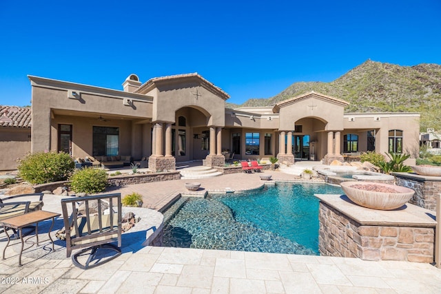 back of house featuring an outdoor living space, ceiling fan, a mountain view, and a patio