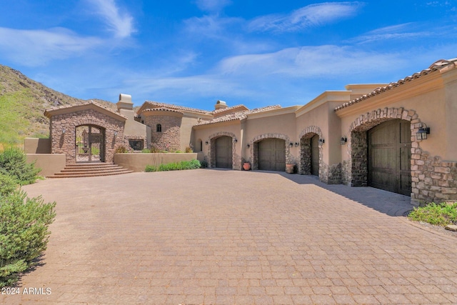 mediterranean / spanish home featuring a mountain view, a garage, and french doors