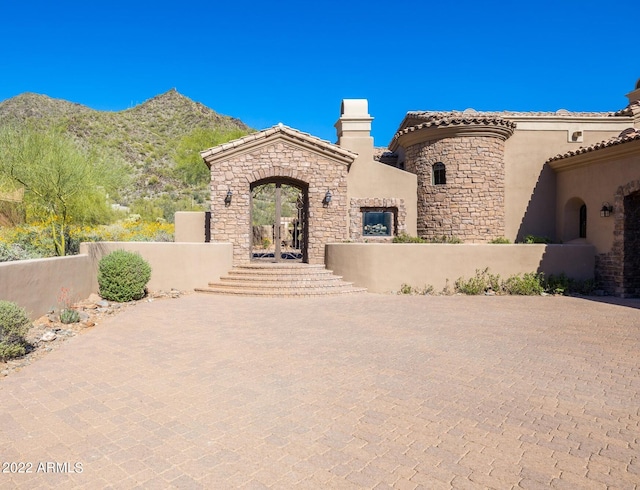 mediterranean / spanish house with a mountain view and french doors