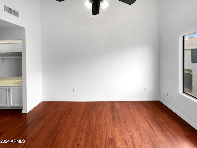 unfurnished bedroom with ceiling fan and wood-type flooring