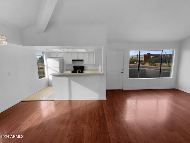 interior space featuring beam ceiling and light wood-type flooring