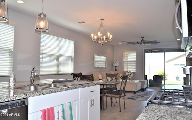 kitchen featuring white cabinetry, a wealth of natural light, stainless steel dishwasher, and sink