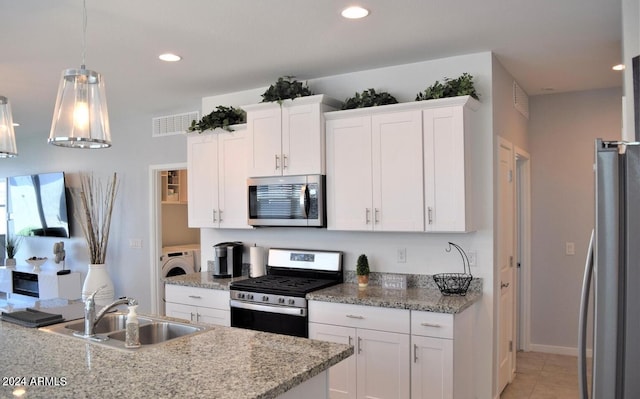 kitchen featuring pendant lighting, white cabinetry, sink, and stainless steel appliances