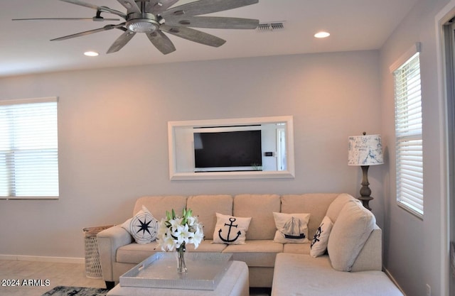 living room with ceiling fan and light tile patterned floors