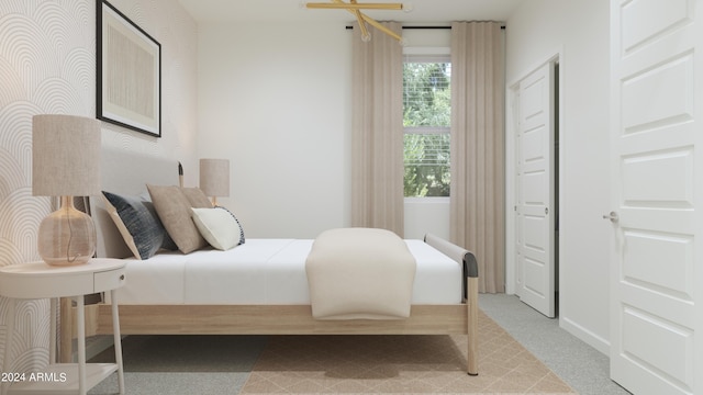 bedroom with light colored carpet and wallpapered walls