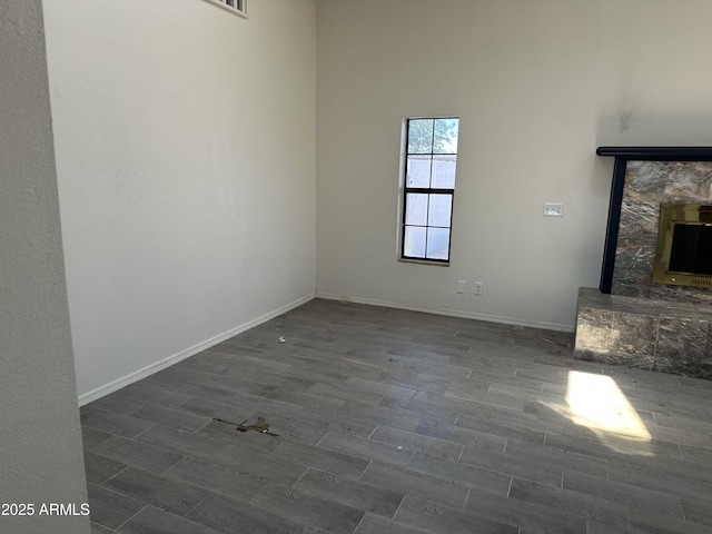 121 N Brown Ave, Casa Grande, AZ 85122 - empty room with dark wood-type flooring and a stone fireplace