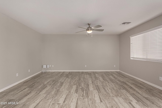 spare room featuring ceiling fan and light hardwood / wood-style flooring