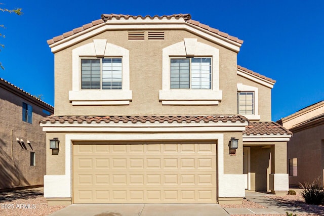 mediterranean / spanish home featuring a garage