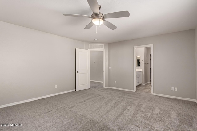 unfurnished bedroom with ensuite bathroom, ceiling fan, and light carpet