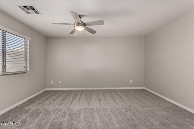 carpeted spare room with ceiling fan