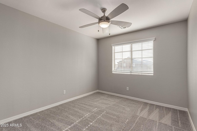 carpeted empty room featuring ceiling fan