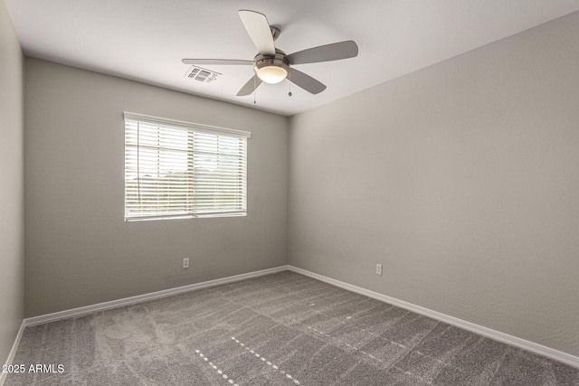 empty room featuring ceiling fan and carpet