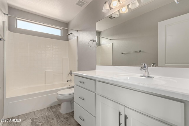 full bathroom featuring toilet, hardwood / wood-style flooring, shower / tub combination, and vanity