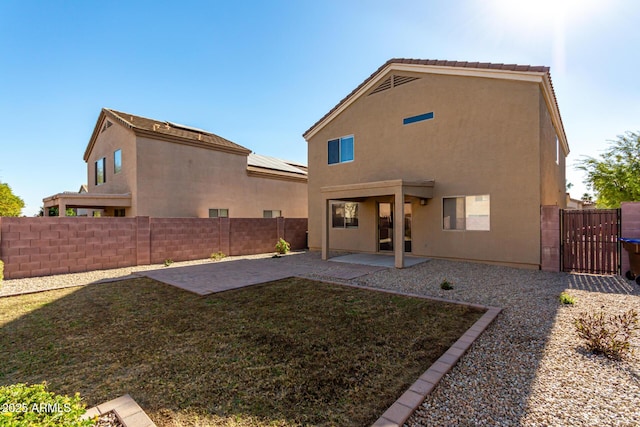 rear view of property featuring a patio