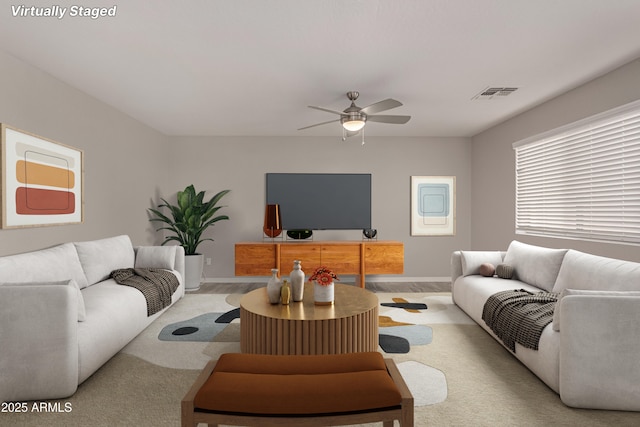 living room with ceiling fan and light colored carpet