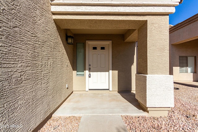 property entrance featuring a patio